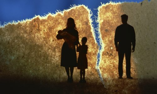 Silhouettes of a family divided by a bright fissure, symbolizing separation or Custody issues.